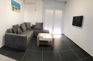 a living room with a couch and a coffee table at Lanika Apartments in Ulcinj