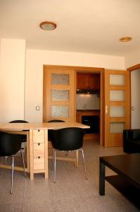 a room with a wooden table and two chairs at Apartamentos Indasol in Salou +44 photos