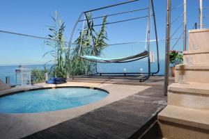 a swimming pool in a house with a hammock at Villa Cablex in Crveni Vrh
