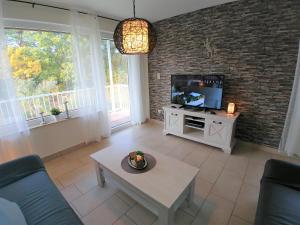 a living room with a couch and a tv at Haus Spengler in Celle