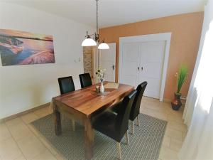 a dining room with a wooden table and black chairs at Haus Spengler in Celle