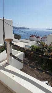 a view of the ocean from a white building at Caldera Boutique in Astypalaia