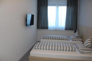 Postel nebo postele na pokoji v ubytování Hotel Lumi