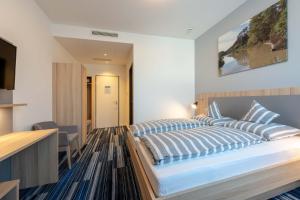 Postel nebo postele na pokoji v ubytování Hotel Lumi