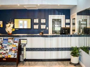 a bar in a store with blue walls at Villager Lodge Niagara Falls in Niagara Falls