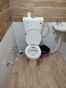 a bathroom with a white toilet and a sink at Om Trance Hostel in Jaipur