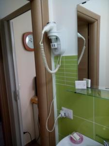 a bathroom with a phone on the wall next to a mirror at Bed And Breakfast Priscilla in Regalbuto