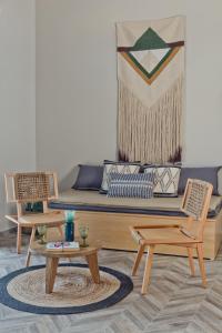 a living room with a couch and two chairs at Kalimera Karpathos Exclusive Villas in Afiartis