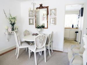 a dining room with a white table and chairs at Beautiful Lymington New Forest Getaway in Lymington