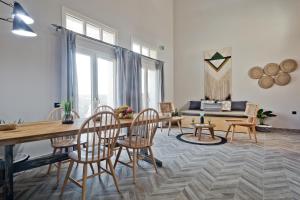 a living room with a wooden table and chairs at Kalimera Karpathos Exclusive Villas in Afiartis