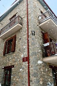 a stone building with snow on the side of it at Konaki Tselepi in Arachova