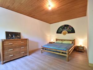 a bedroom with a bed and a wooden ceiling at Superb holiday home with private garden in Yvias