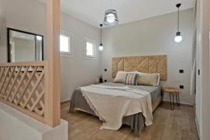 a bedroom with a large bed in a room at Kalimera Karpathos Exclusive Villas in Afiartis