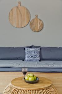 a table with a bowl of fruit on top of a couch at Kalimera Karpathos Exclusive Villas in Afiartis