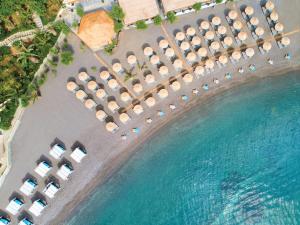 an aerial view of a resort with chairs and water at Out Of The Blue Resort & Spa in Agia Pelagia