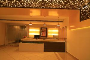 a lobby with a reception desk in a building at TM Hotel in Madurai