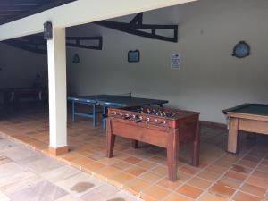 a room with two ping pong tables and a pool table at Recanto da Enseada - Condomínio Via Marina in Ubatuba