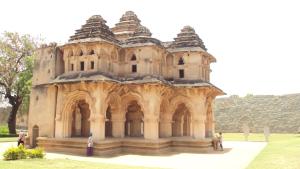 a building with people standing in front of it at Rks Homestay in Hampi