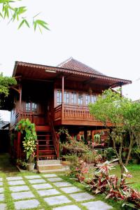 a large wooden house with a pathway in front of it at Oemah Kajoe Lembang in Lembang