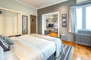 アテネにあるSuperb 1BD Apartment in the heart of Kolonaki by UPSTREETのベッドルーム(大きな白いベッド1台、窓付)
