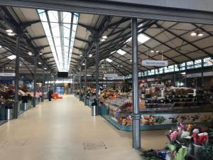 a large building with a market with fruits and vegetables at Castelo do Relógio by Férias em Figueira in Figueira da Foz