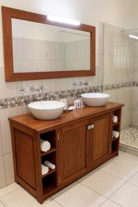 a bathroom with two sinks and a mirror at Batonka Guest Lodge in Victoria Falls