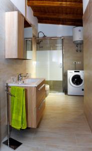 a kitchen with a sink and a washing machine at Casa del Melograno 42 in Roccalumera
