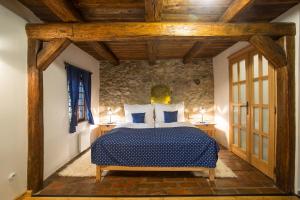 a bedroom with a bed in a room with wooden ceilings at ANTIK in Štramberk