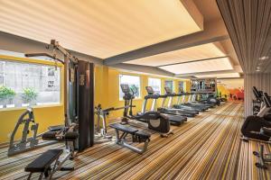 a gym with a row of treadmills and ellipticals at ibis Kolkata Rajarhat - An Accor Brand in Kolkata