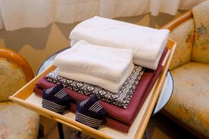 a tray with towels and socks on a table at HAKONE GORA ONSEN Hotel Kasansui in Hakone