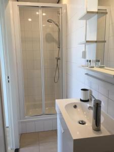 a bathroom with a shower and a sink at Pension Zandvoort aan Zee in Zandvoort