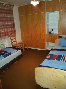 Lissendorf的住宿－Ferienhaus Ammermann，一间卧室配有两张床、一张桌子和一把椅子