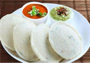 a white plate of food with soup and bread at Rks Homestay in Hampi