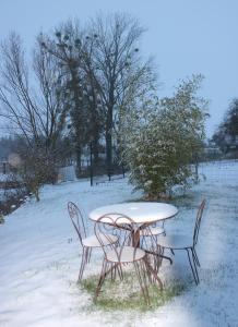 a table and chairs sitting in the snow at CHEZ SANDRINE in Surbourg