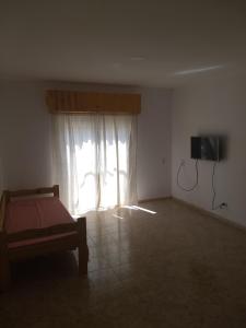 ラス・トニナスにあるMajomi Las Toninasのベッドルーム1室(ベッド1台付)、窓(テレビ付)