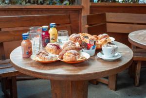a table with plates of pastries and drinks on it at Bed & Breakfast Le Piazze in Cori