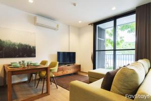 a living room with a couch and a table at The Valley Khaoyai Tropical Style in Ban Huai Sok Noi