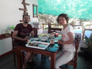 a man and a woman sitting at a table at Marari Coastal Dreams Home Stay in Alleppey