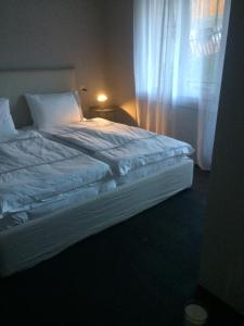 a large bed in a bedroom with a window at Le Bijou in Zermatt