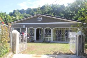 a garage with a gate and a house at ritashomeawayfromhome in Ocho Rios