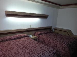 A bed or beds in a room at Hotel Puebla