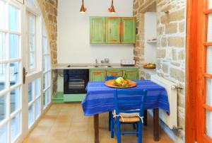 a kitchen with a table with a plate of fruit on it at Cyprus Villages Hotel & Restaurant - Central Location - Bed & Breakfast - With Access To Pool And Stunning Views in Tochni