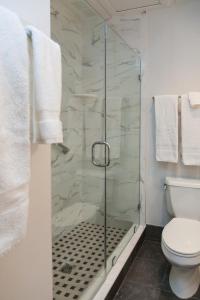 a bathroom with a glass shower with a toilet at John Rutledge House Inn in Charleston
