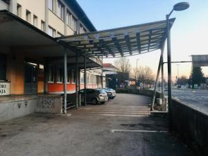 awning over a parking lot outside of a building at Cozy, Bright and Affordable Single Studio - Free Parking in Ljubljana