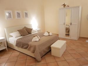 a bedroom with a bed with two stuffed animals on it at Dolce Vita maison chic in Caserta