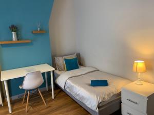 a small bedroom with a bed and a desk at Winstanley House in Wellingborough