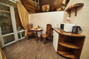 a kitchen with a counter and a table with a microwave at Инь-Янь in Vinnytsya