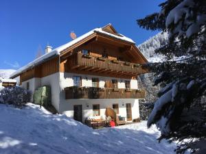 a building with a balcony in the snow at Ferienhaus Sükar in Bad Kleinkirchheim