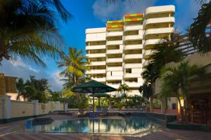 a hotel with a swimming pool in front of a building at Atrium Beach Resort and Spa St Maarten a Ramada by Wyndham in Simpson Bay