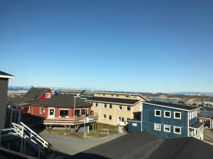 a view of a town with houses and the ocean at Hotel Nuka in Ilulissat